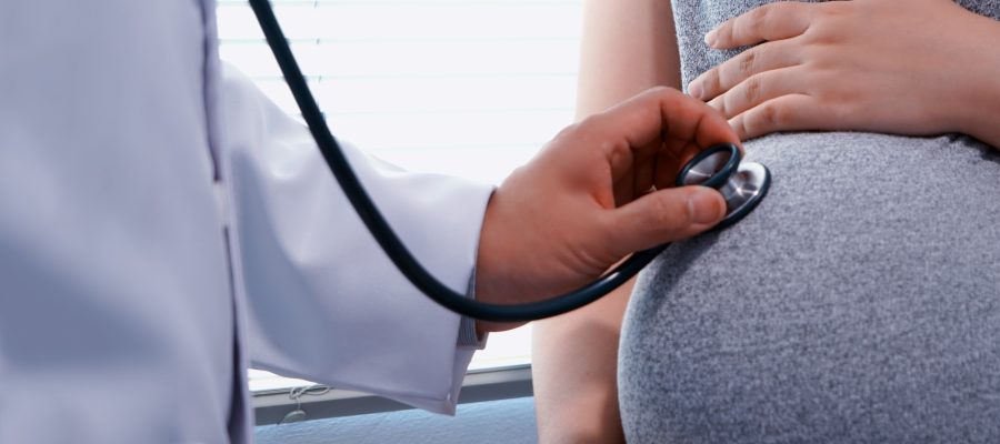 doctor-listening-to-belly-of-pregnant-women.jpg